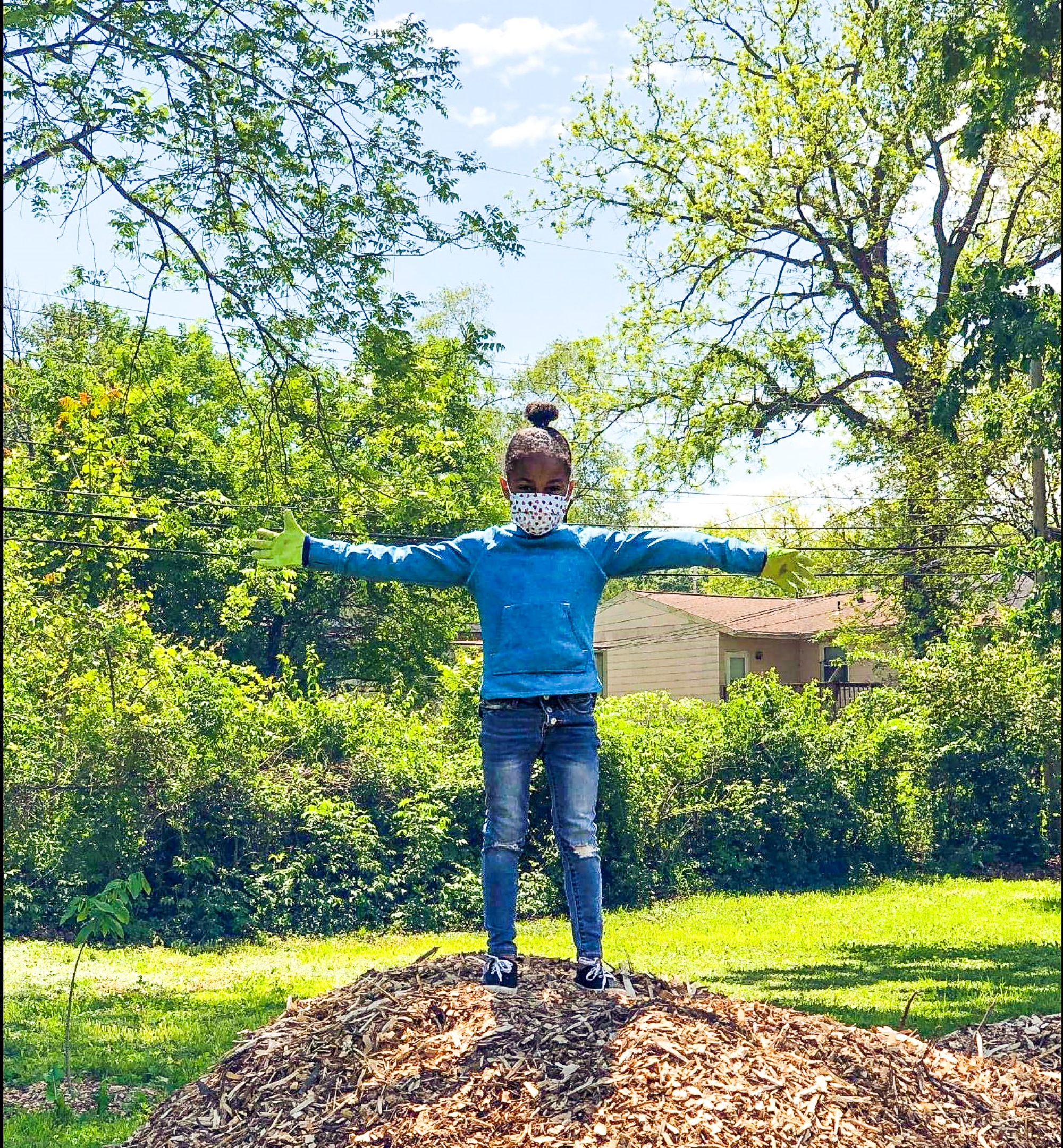 a young girl standing in leaves